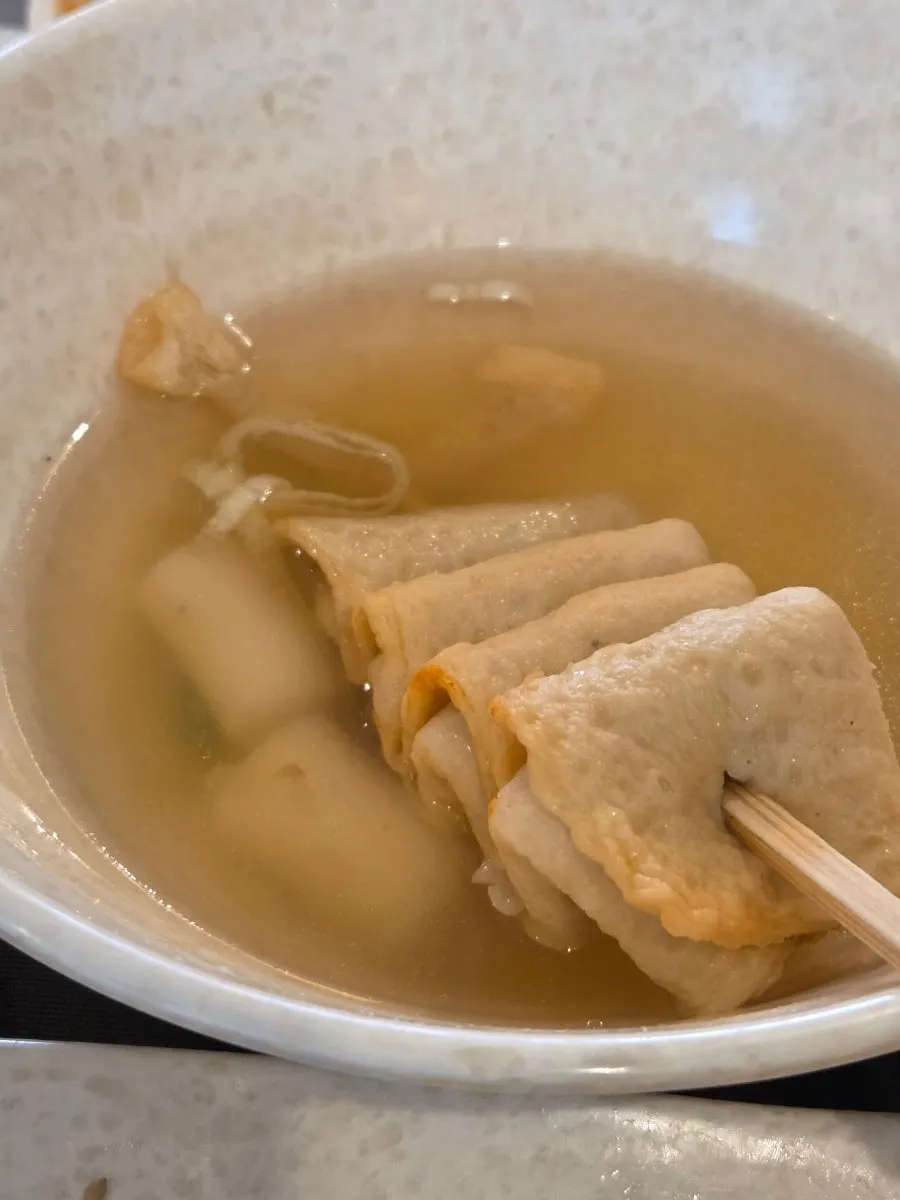 A bowl of skewered fish cake broth