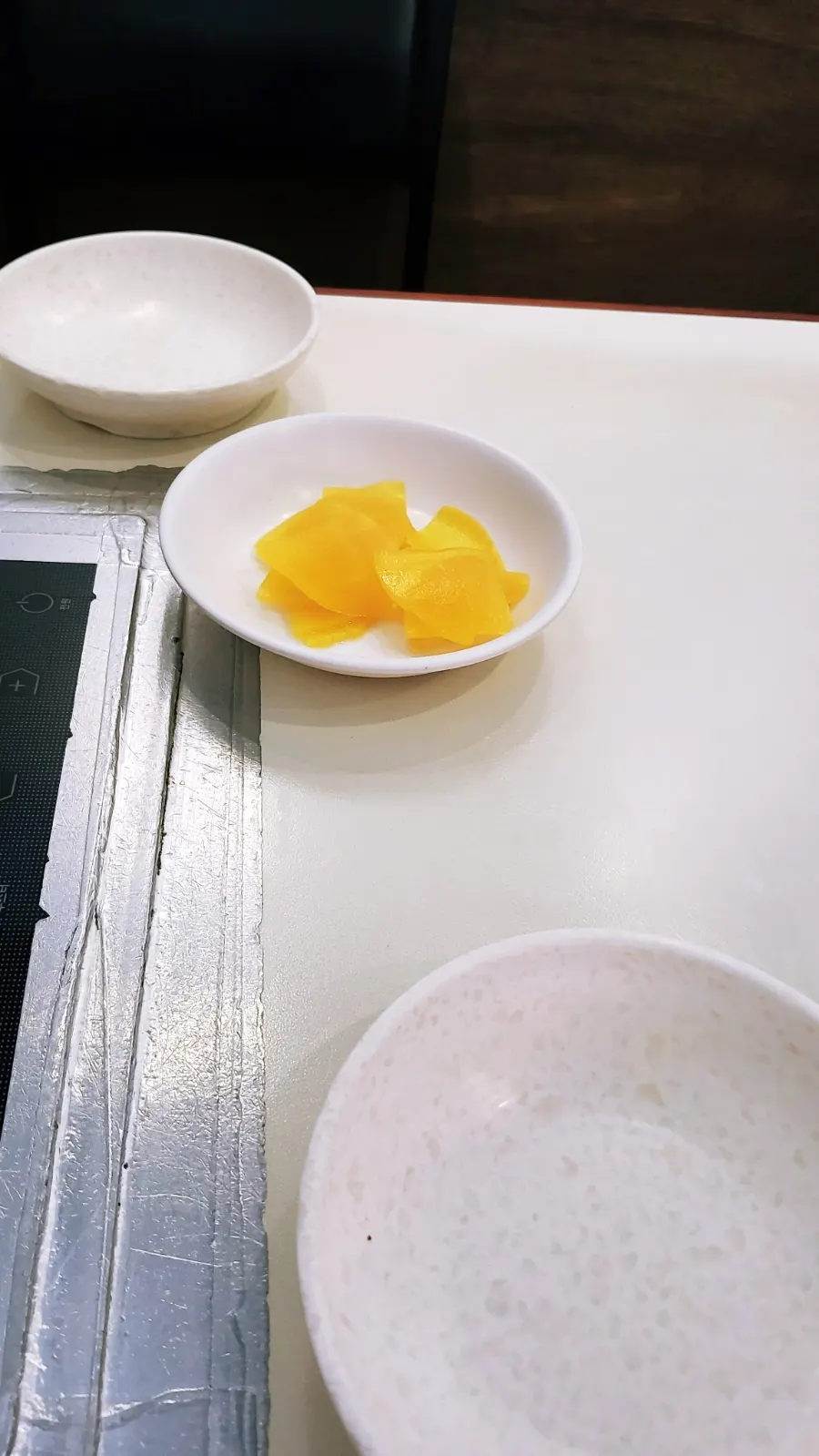 Pickled radish and water from the self-serve bar
