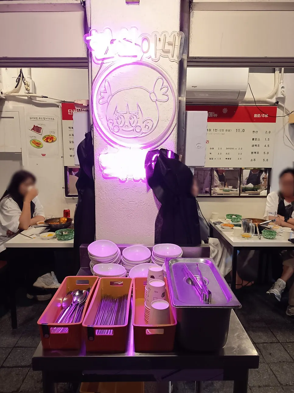 Self-serve corner with utensils and small plates