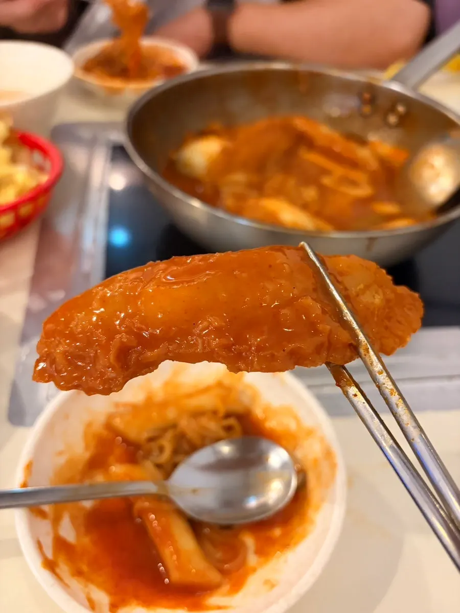 Rice cakes and noodles well coated in sauce