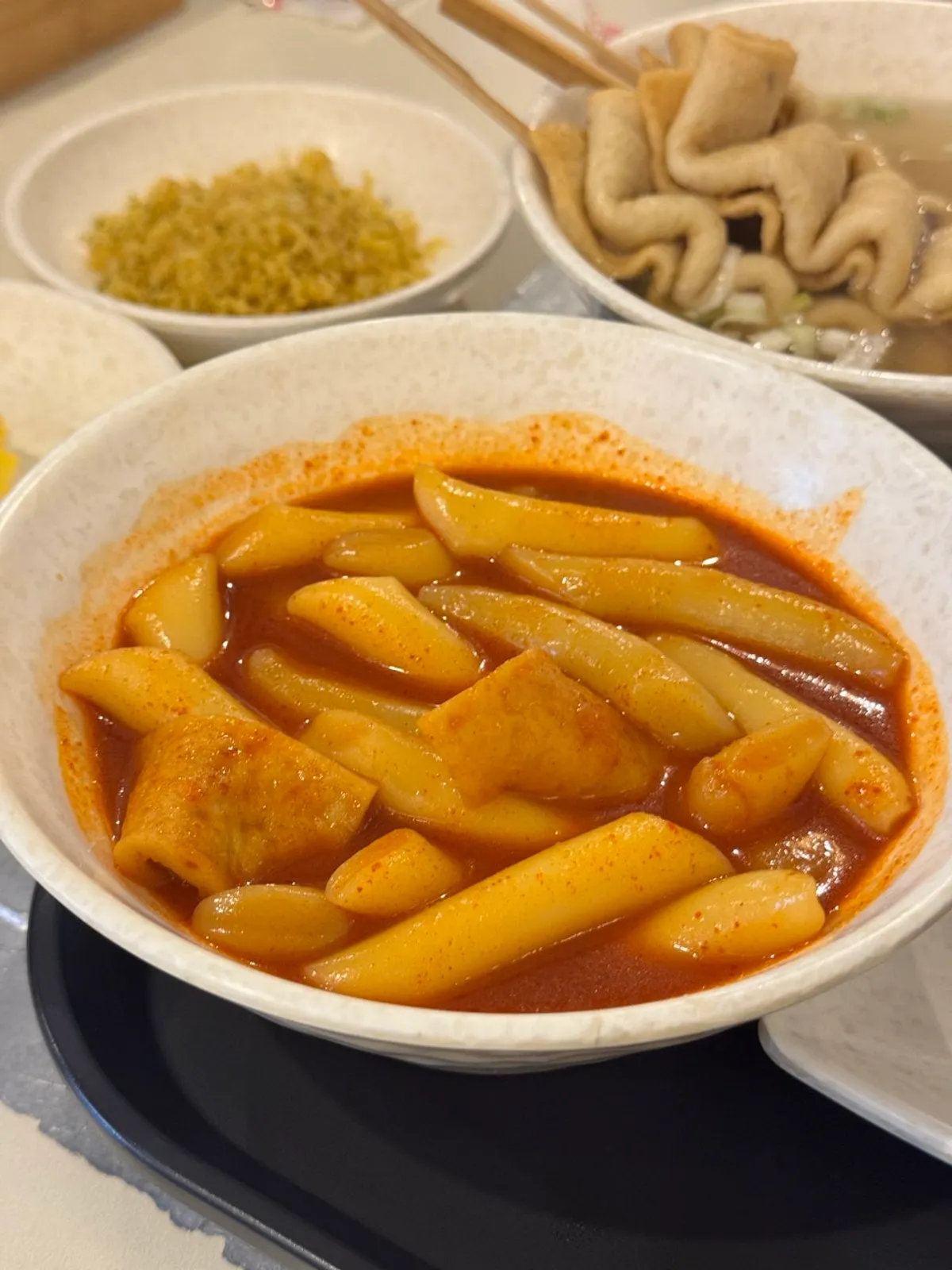 Spicy sauce served separately in a paper cup