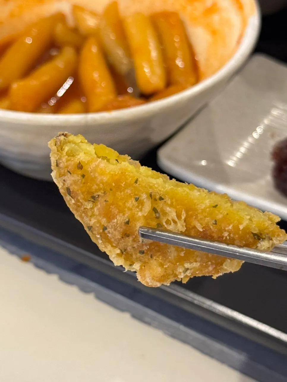 Fish cake broth served in a paper cup