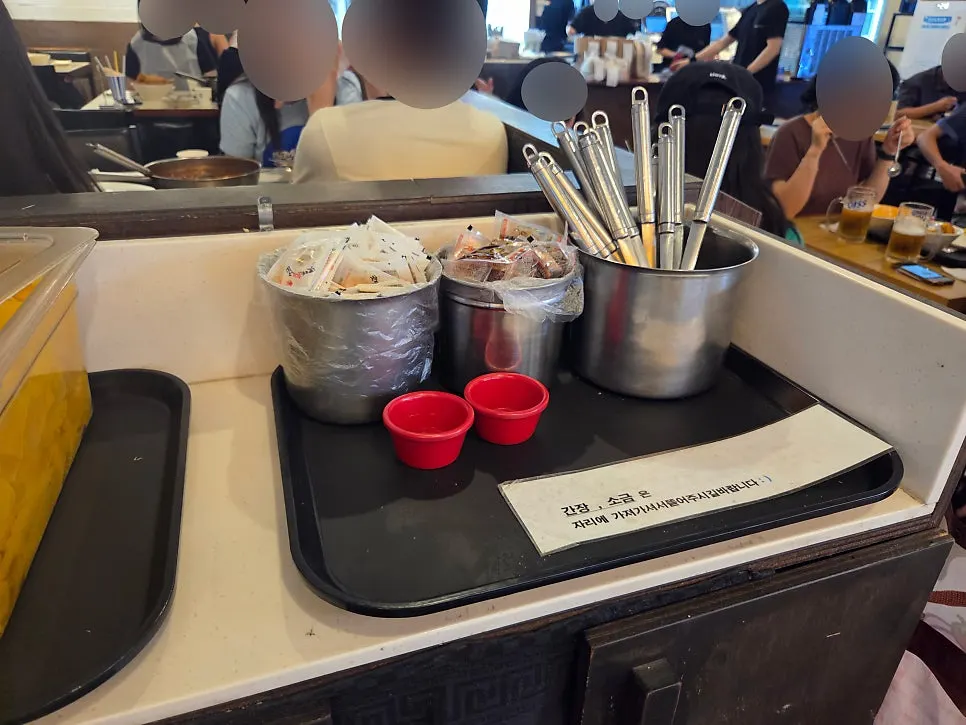 Self bar next to the kiosk with pickled radish and wet wipes