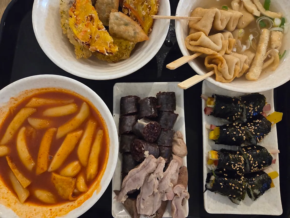Hyeonseonine Combo spread with tteokbokki, sundae, mini gimbap, fritters, and fish cake