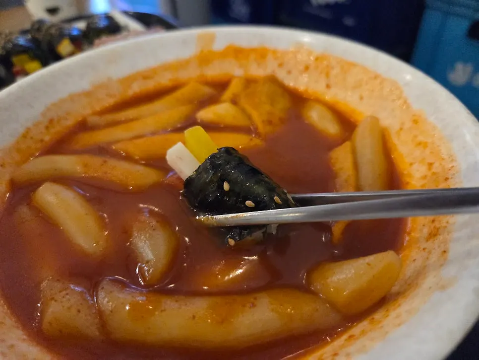 Close-up of a chewy bite of tteokbokki rice cake