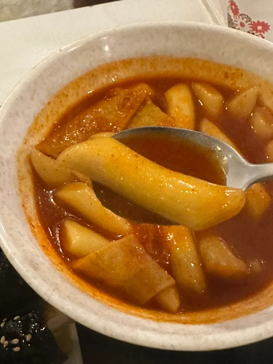 A bite of tteokbokki with mini gimbap