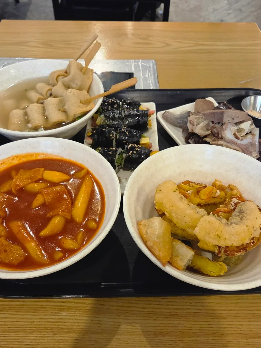 Full Hyeonseonie combo set spread with tteokbokki, fritters and sundae