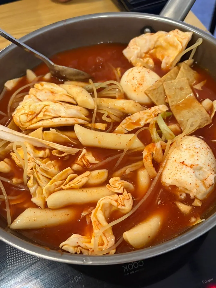Instant tteokbokki bubbling at the table
