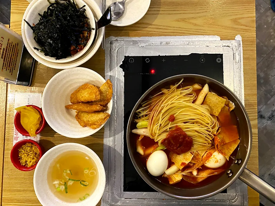 Table setup for instant tteokbokki for two with self-serve fried rice at Hyeonseonine Yongsan Main Branch