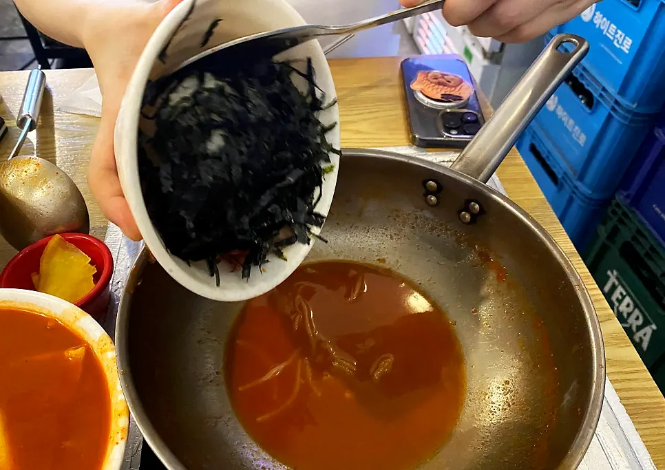 Pot with remaining broth before the fried rice goes in