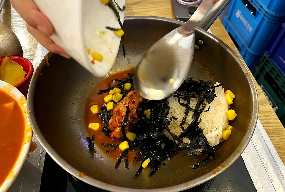 Mixing fried rice into the pot