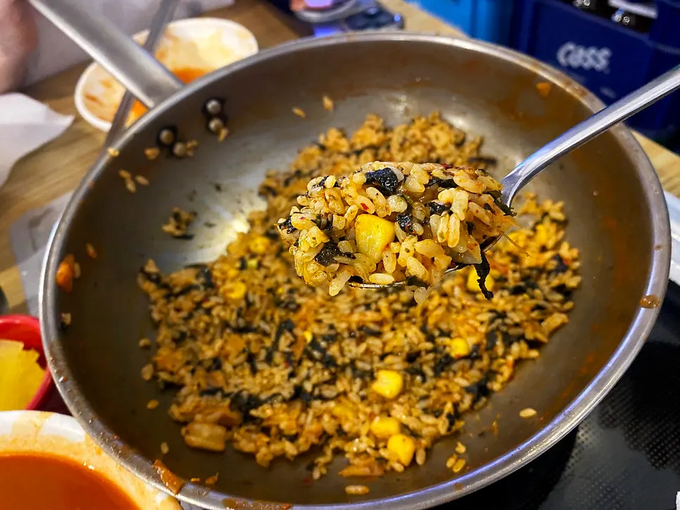 Finished fried rice with sesame oil, aged kimchi, and seaweed flakes