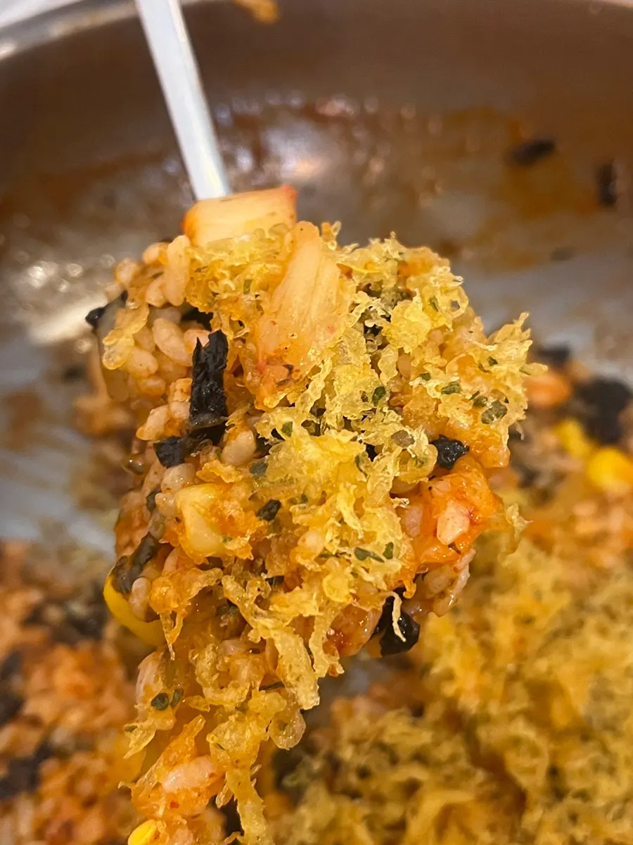 Finished fried rice topped and pressed with fried batter bits