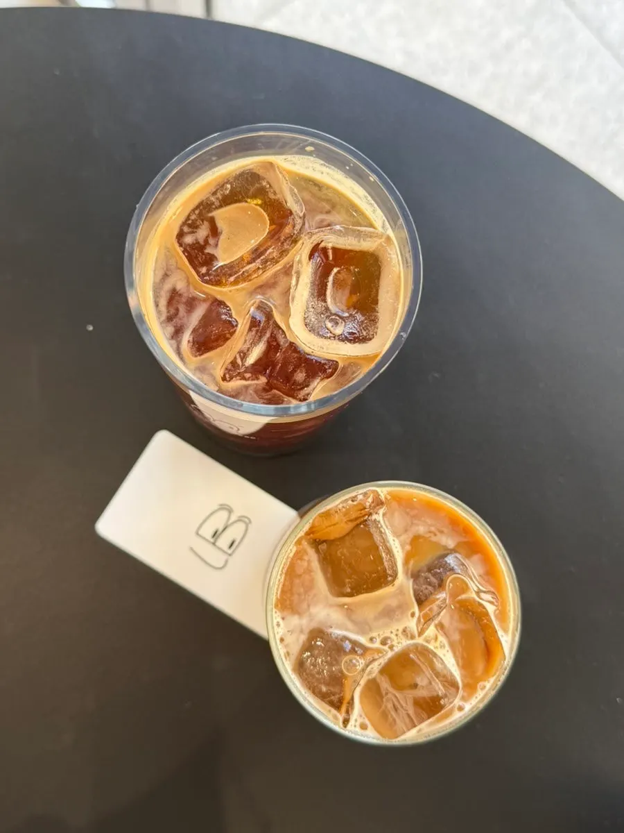 Iced café latte filled to the brim of the cup