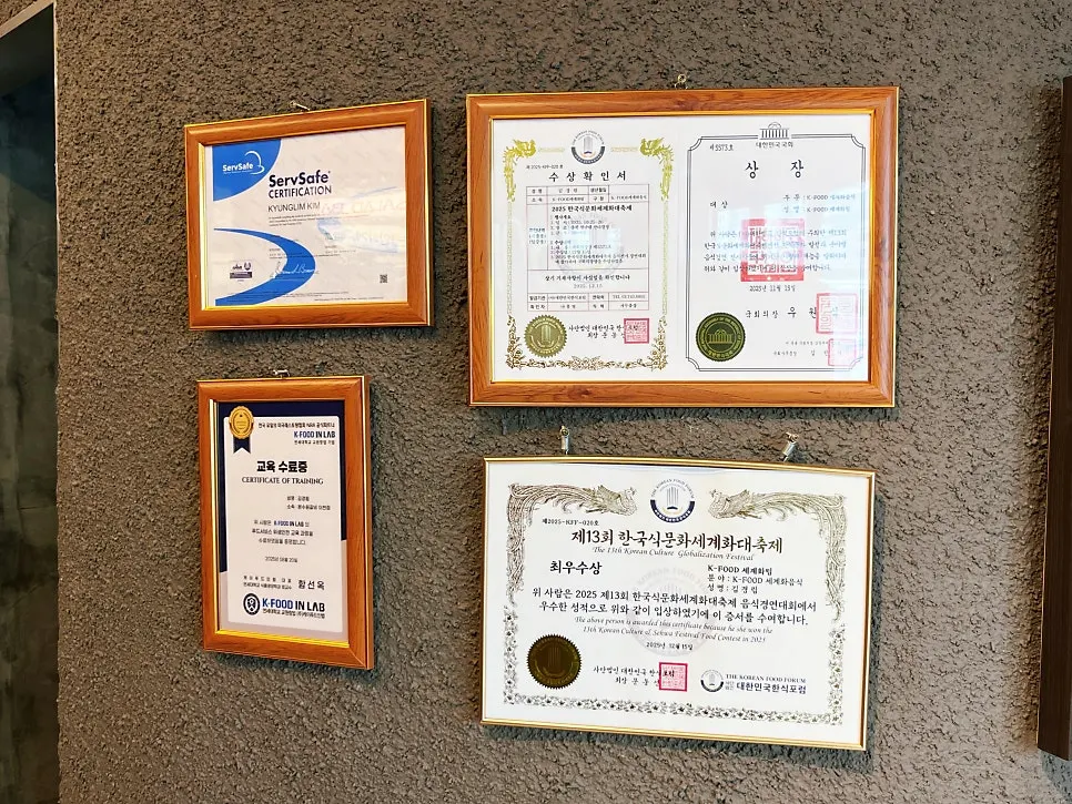 Certificates and plaques from the master Korean chef displayed in the store