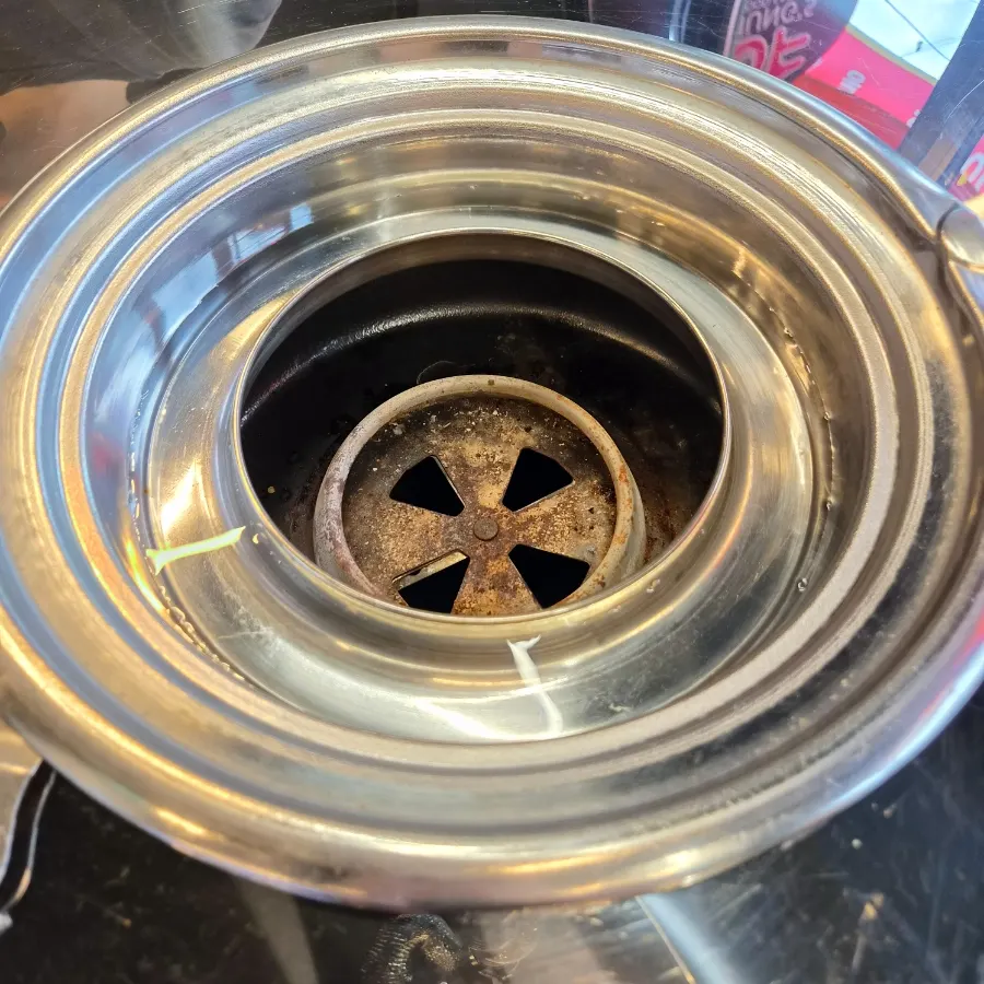 Charcoal grill table with water poured around the rim