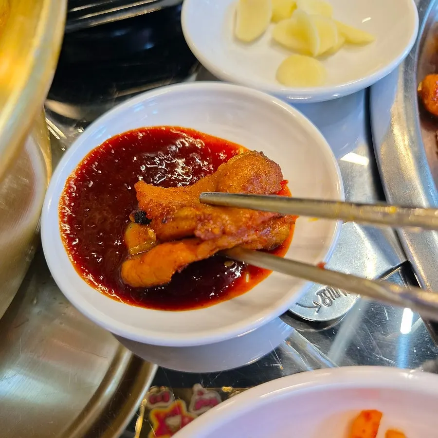 A piece of meat dipped in the spicy sauce