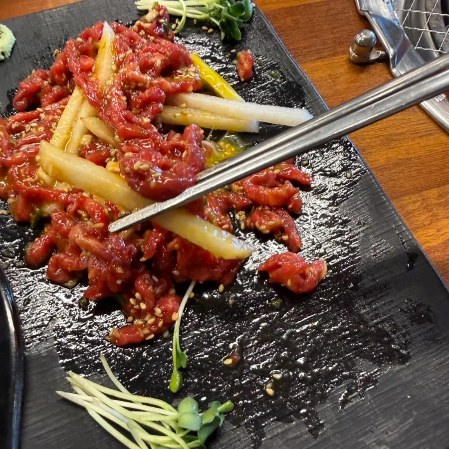 A plate of yukhoe topped with sesame seeds