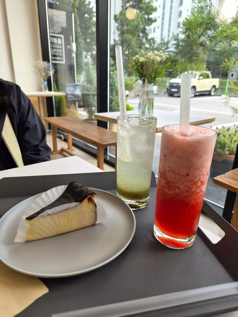 Table spread of Basque cheesecake and ade at Lapins