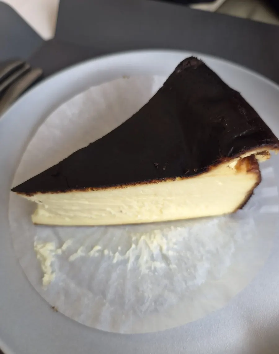 A forkful cut from the Basque cheesecake
