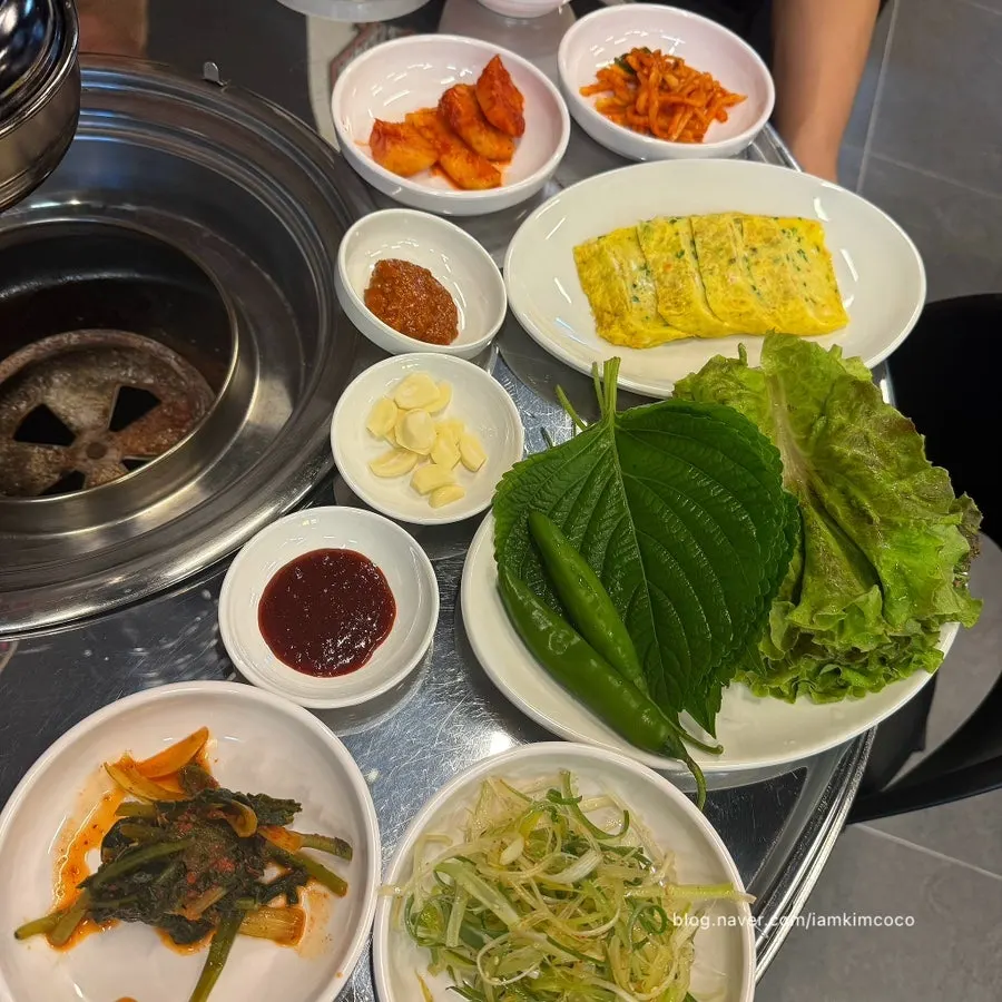 Table spread of various banchan served with the meat