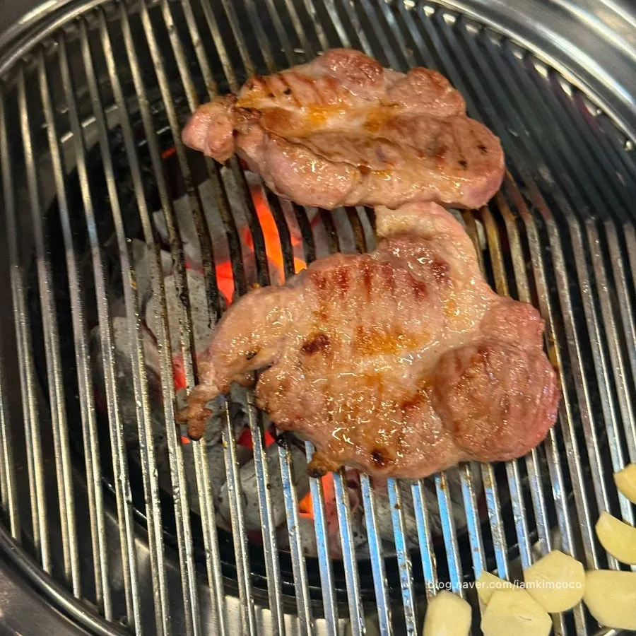 Garlic grilling alongside the pork neck