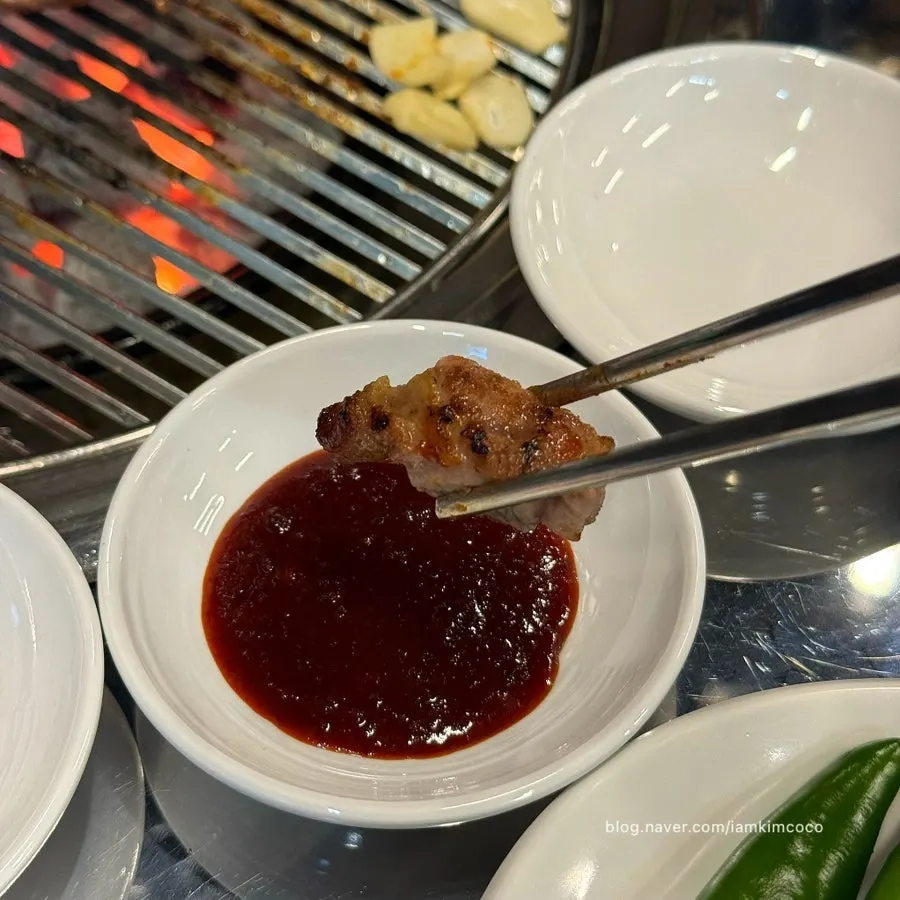 A piece of pork neck dipped in salt