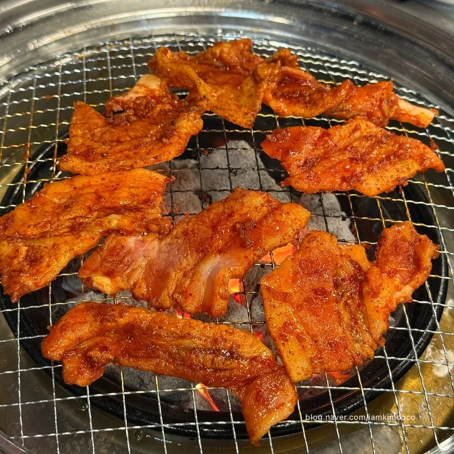 Red fresh pork belly cooking on the charcoal grill