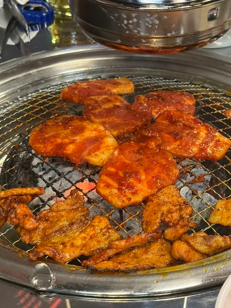A piece of red donggeurangttaeng placed on a wrap green