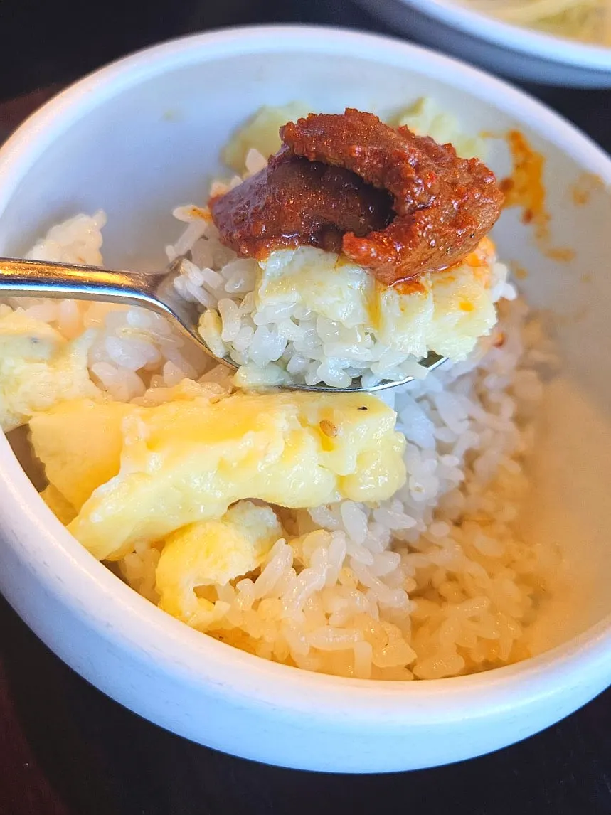 A piece of pork placed on top of the pot rice