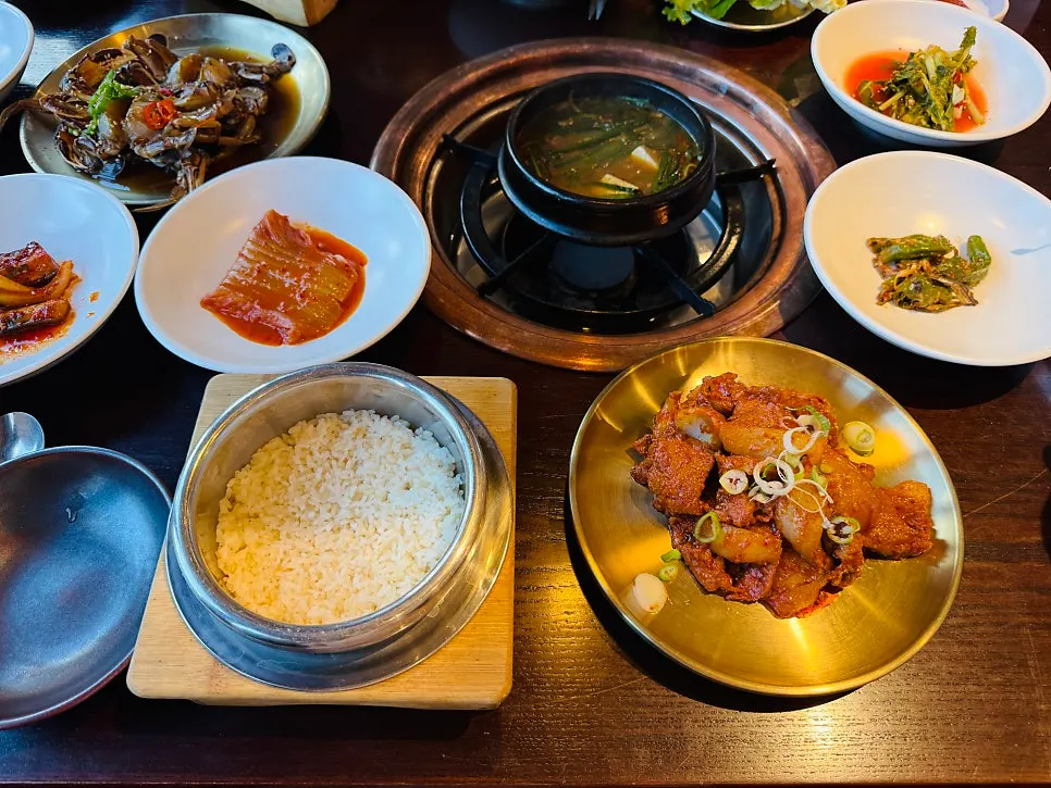 A spoonful of pot rice topped with side dishes