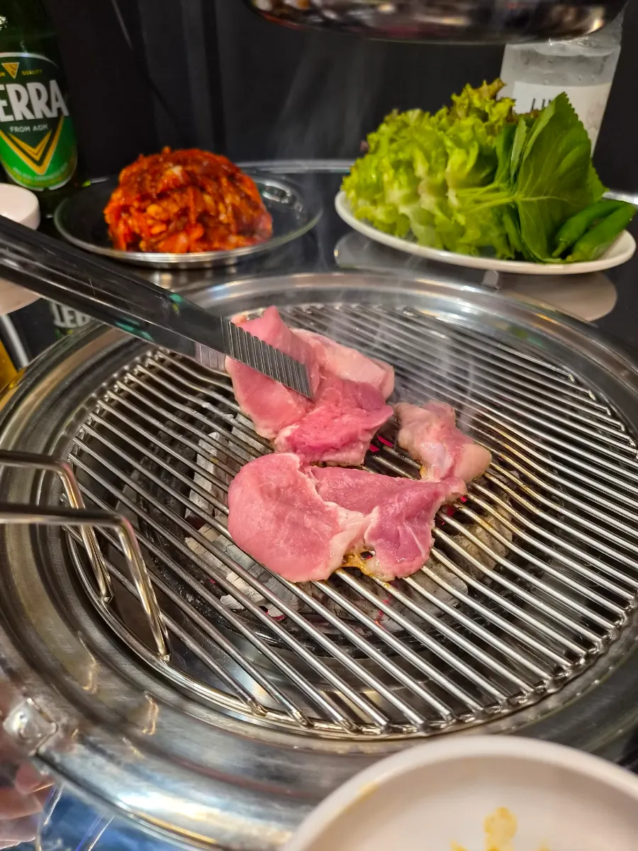 Fresh pork neck placed on the grill