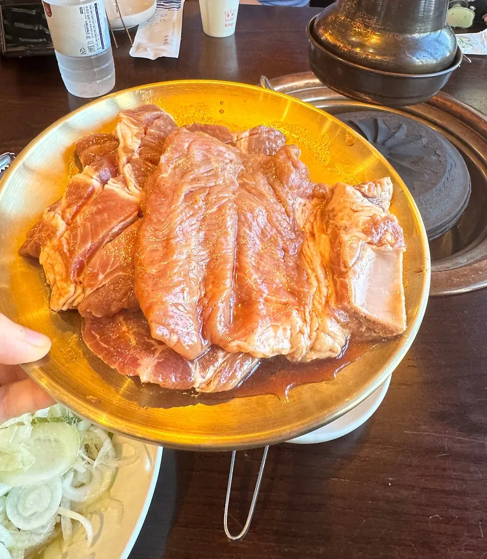 Two servings of nuruk-marinated pork galbi still on the bone