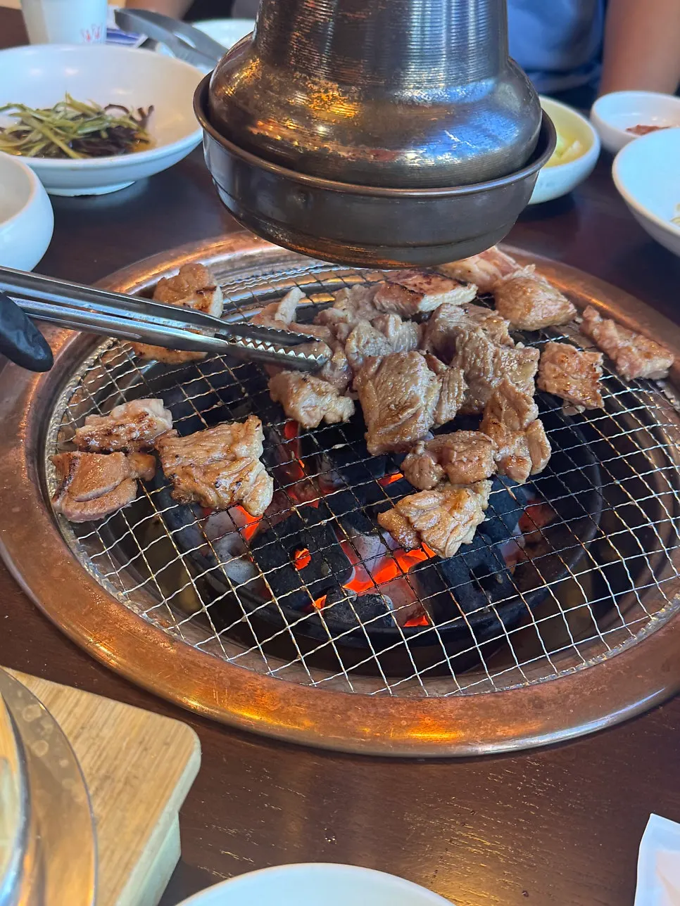 Nuruk-marinated pork galbi grilling on the tabletop grill