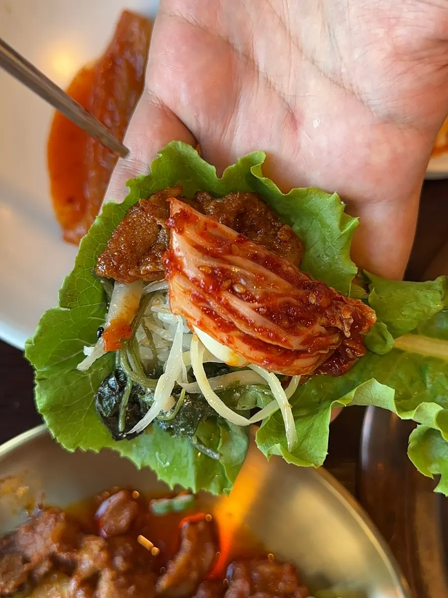 Jeyuk bokkeum placed on a ssam vegetable