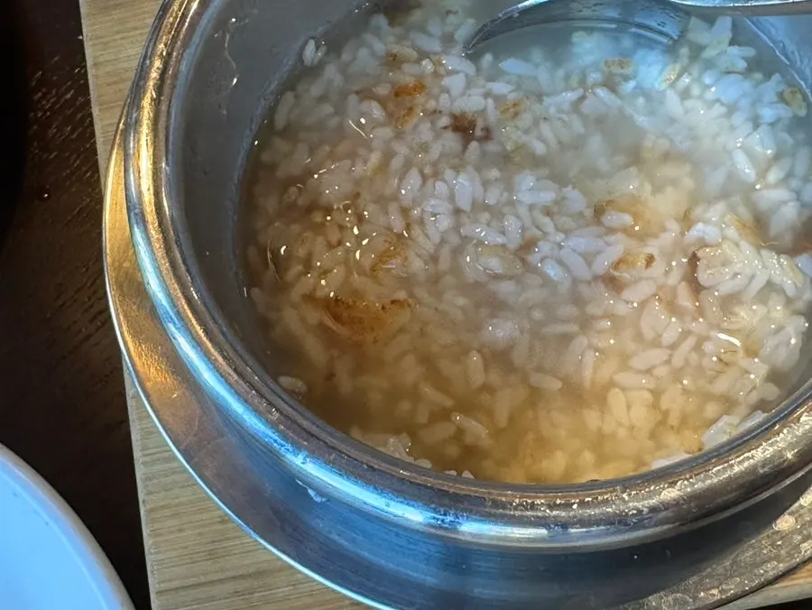 A spoonful of pot rice topped with soy crab