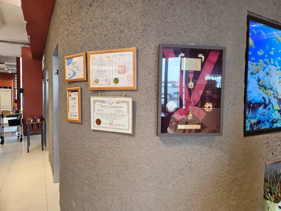 Corner of the restaurant displaying traditional Korean cuisine certificates