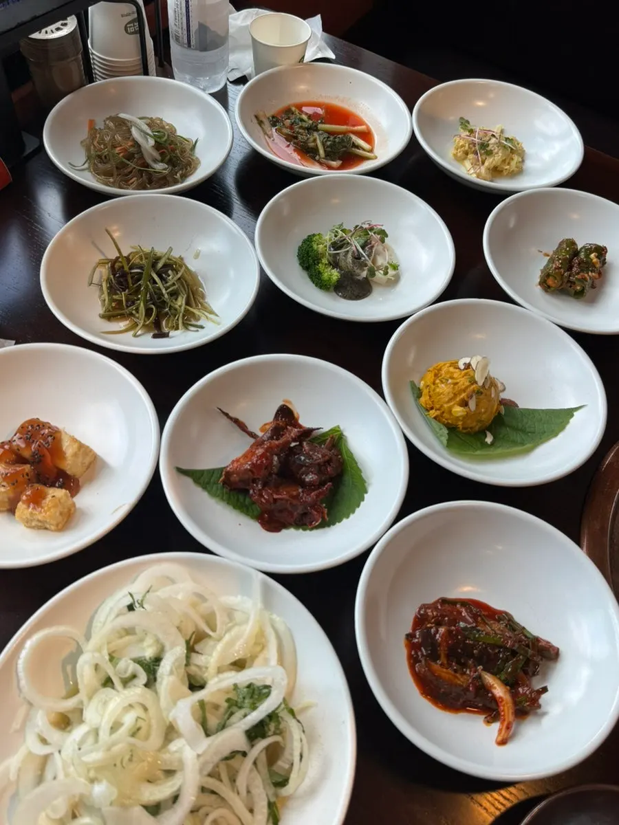 Full spread of side dishes served after ordering