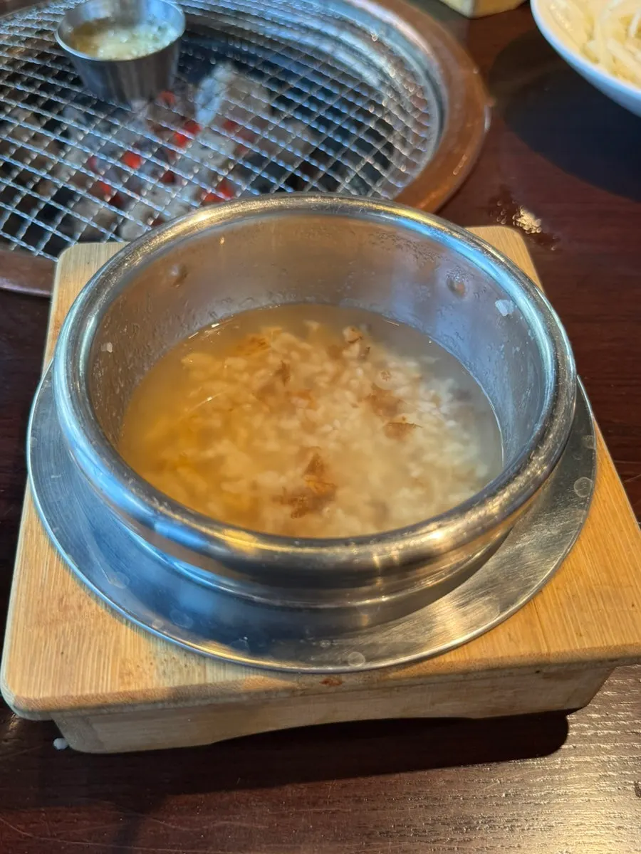 Opened lid revealing hwangmi pot rice