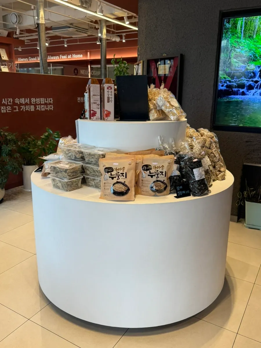 Outdoor terrace lounge with jangdokdae jars and plants