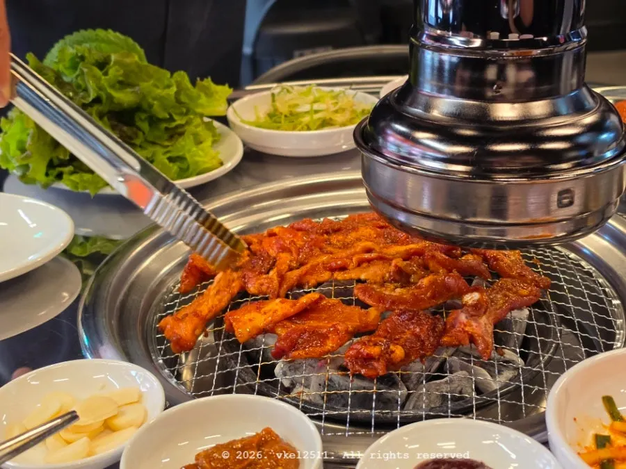 Staff grilling marinated fresh pork belly