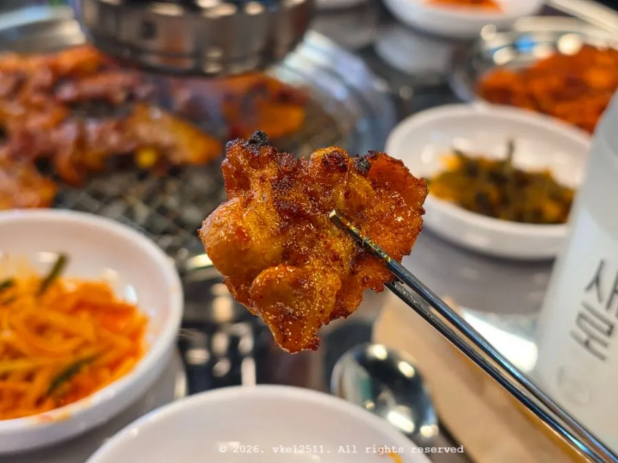 Red fresh pork belly cooking with chopsticks nearby