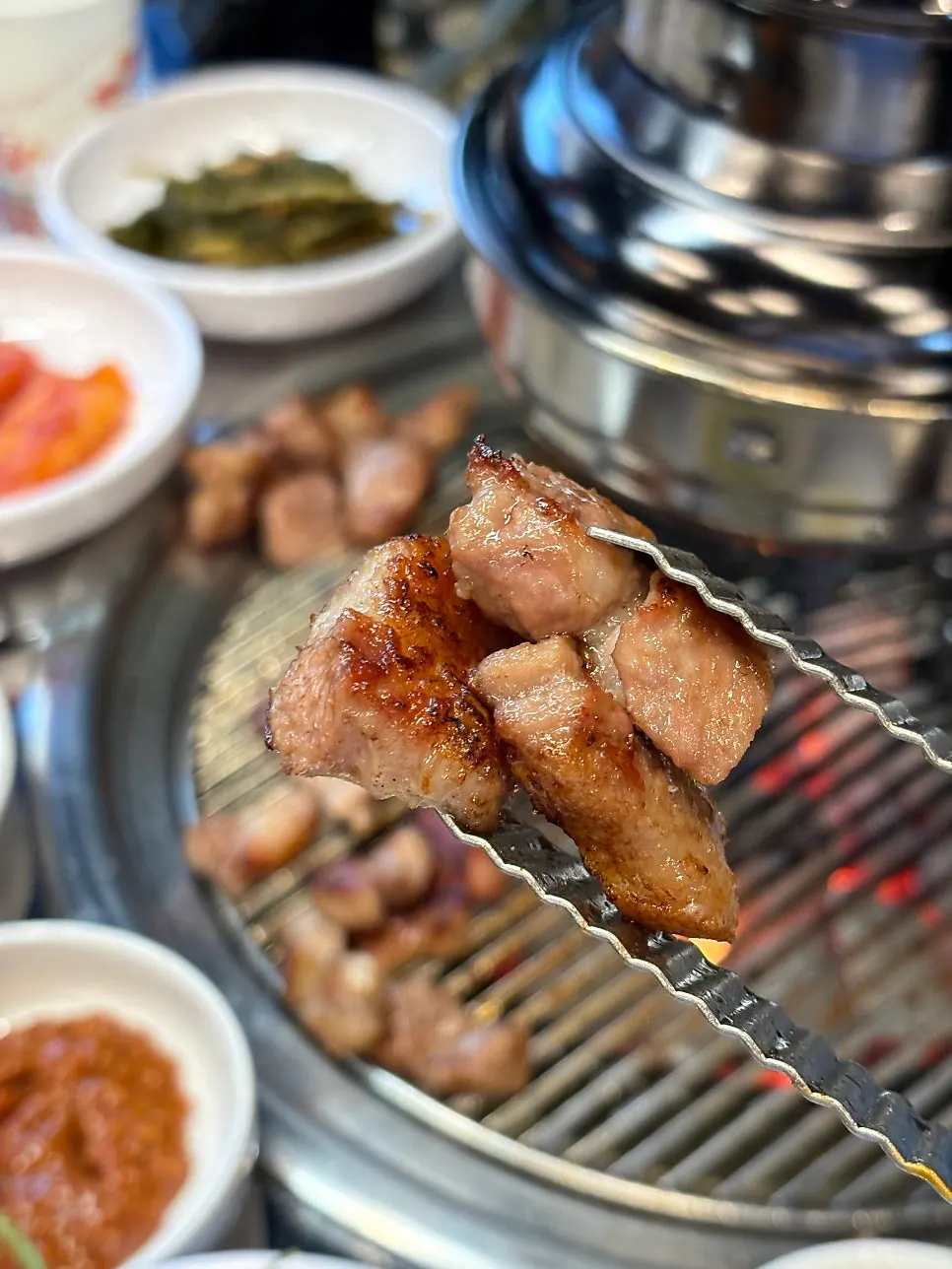 Full spread of charcoal-grilled meat and basic side dishes