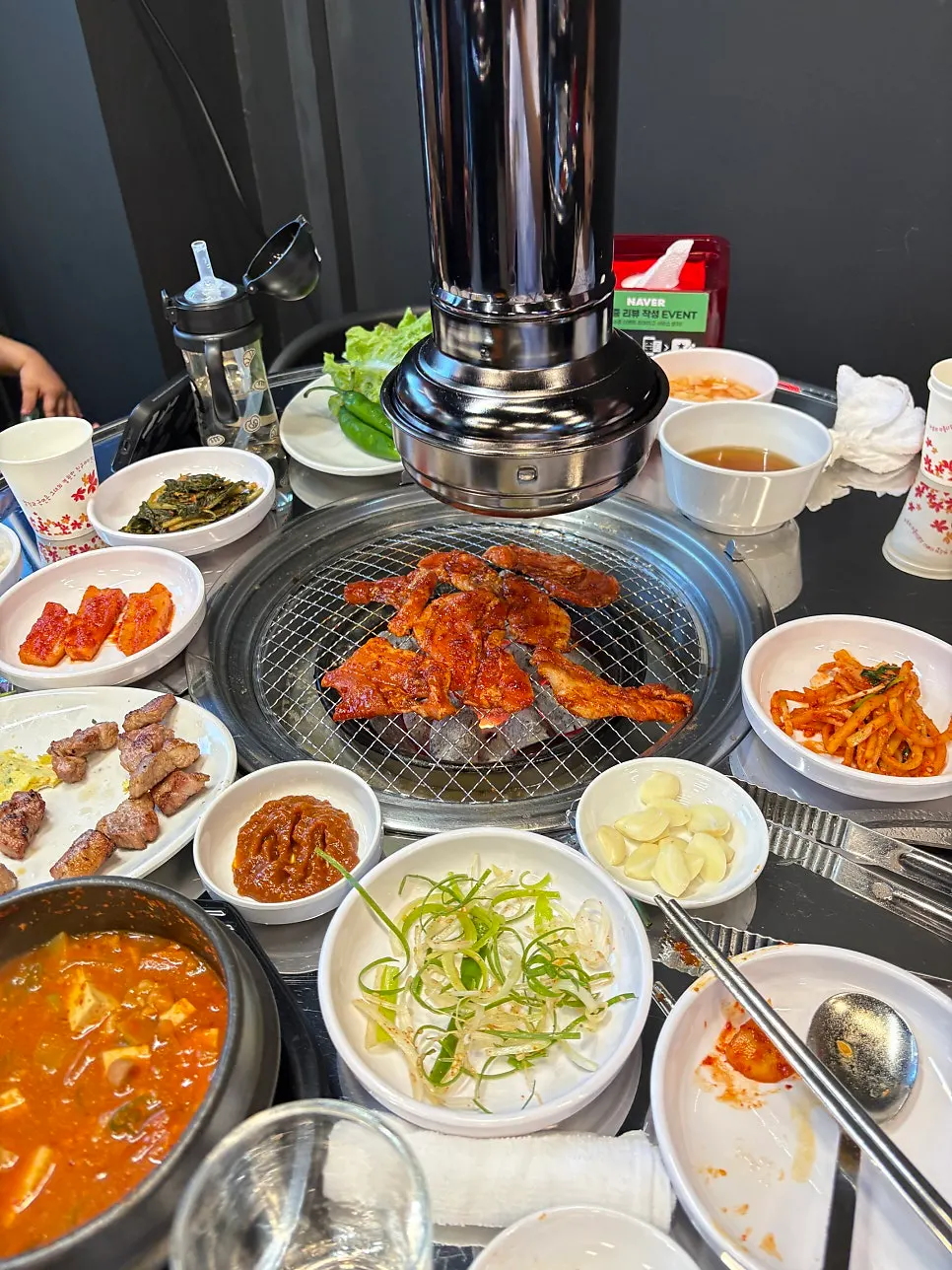 Spicy raw pork belly grilling over charcoal