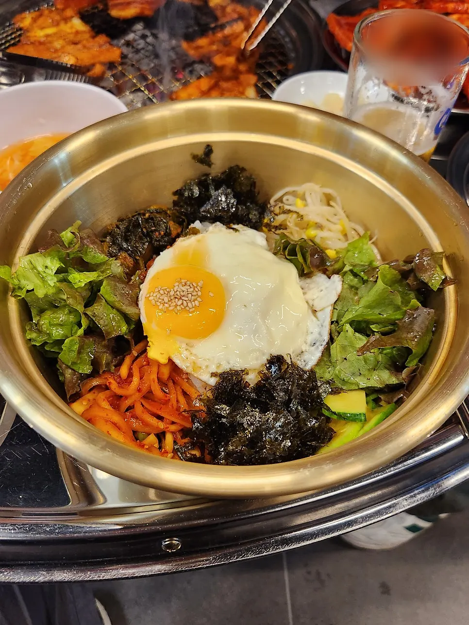 A bowl of bibimbap topped with sauce