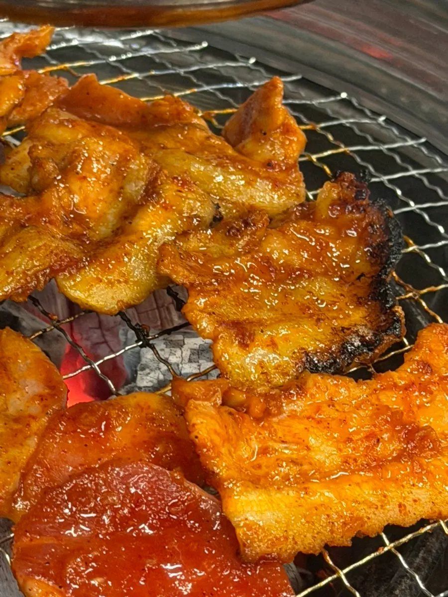 Spicy raw pork belly grilling on the hotplate
