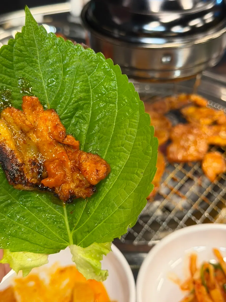 Spicy meat patties made from pork neck being grilled