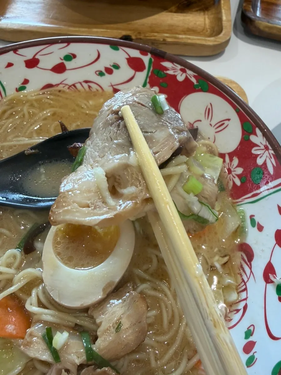 Ramen noodles lifted with chopsticks