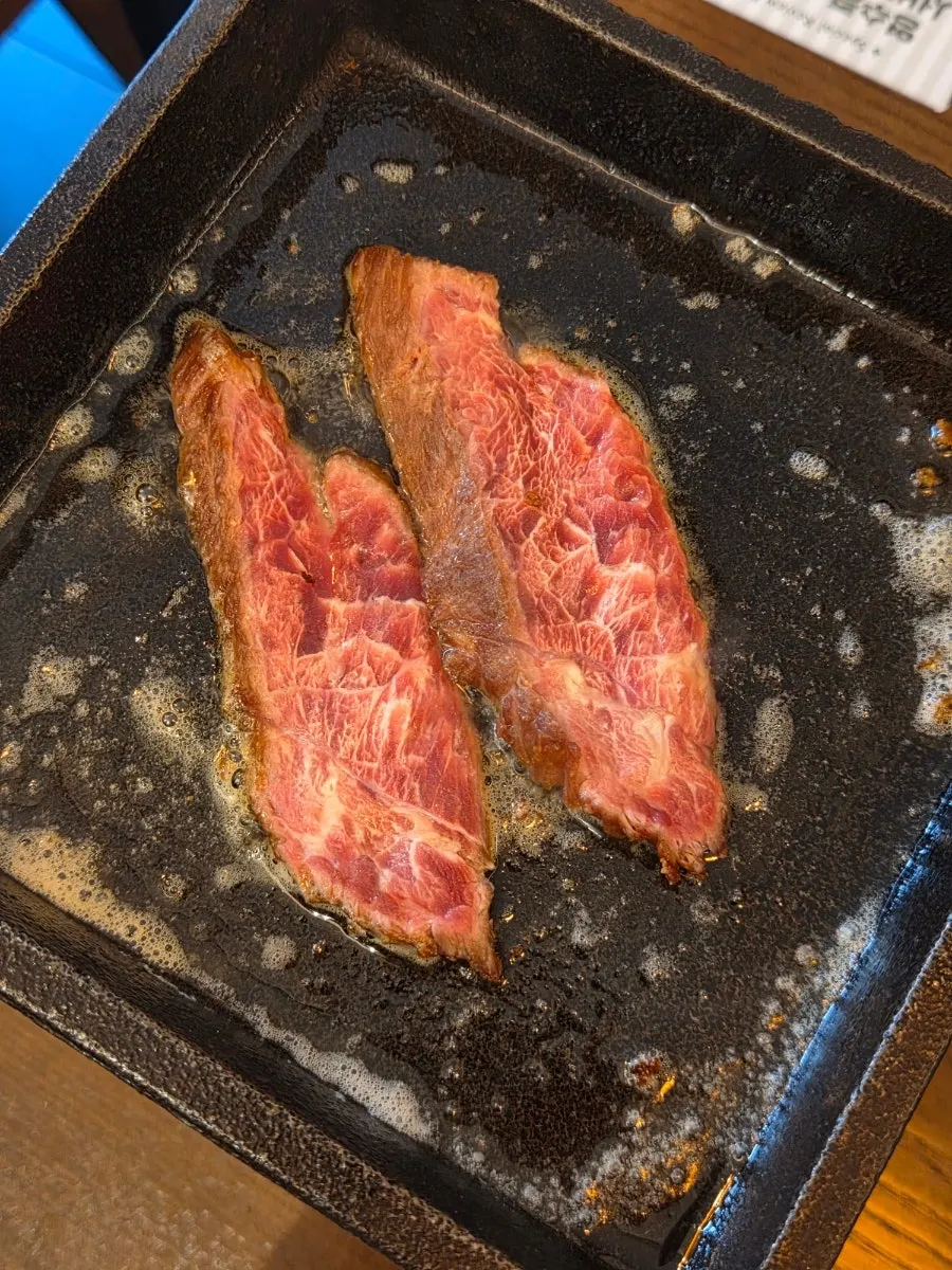 Grilling steak on melted butter over the mini stove