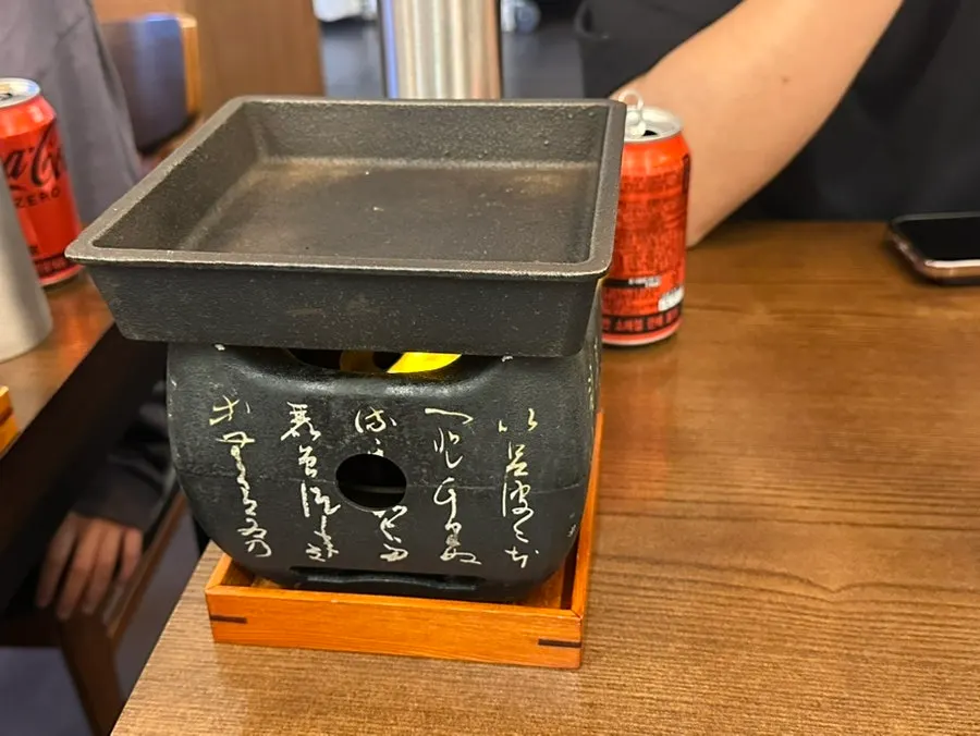 Tabletop grill and drinks set up on the table